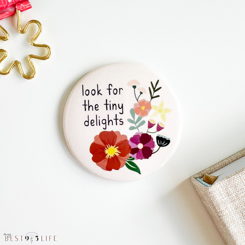 Image of round floral designed magnet by Kwohtations that says look for the tiny delights